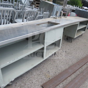 Long work table with under shelf, integrated sink, and multiple outlets. Dimensions: 174x23x35. Used condition.