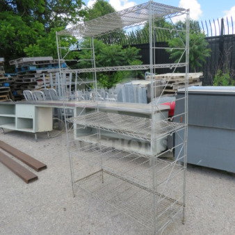 Metal shelving unit with 5 wire shelves, measuring 48x18x73 inches. Outdoor setting, sturdy construction, used condition.
