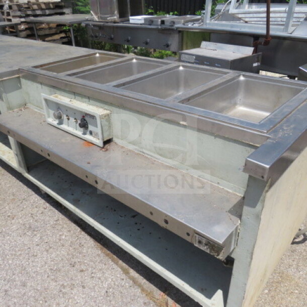 Wells 400 steam table/work table, 126x36x36, with 2 under shelves, stainless steel, 208/240V, visible control panel.