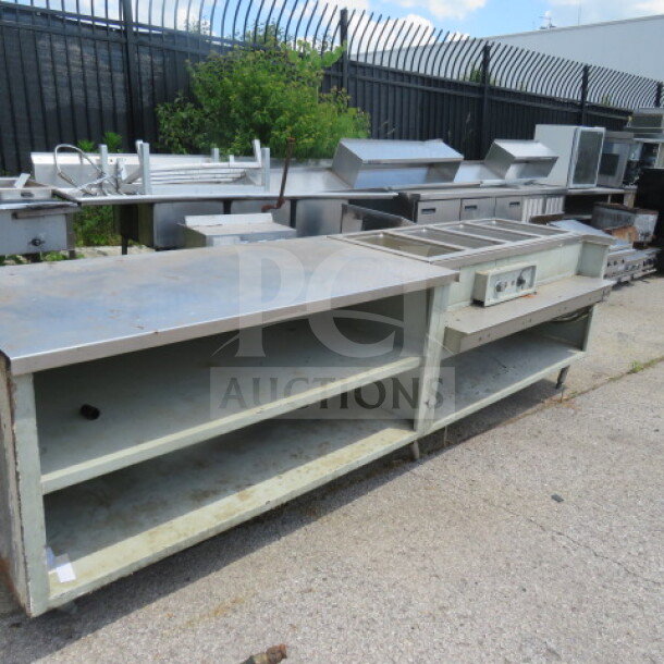 Wells Model 400 steam table/work table with 2 shelves, 126x36x36 inches, 208/240V. Features include 4 wells and signs of wear.