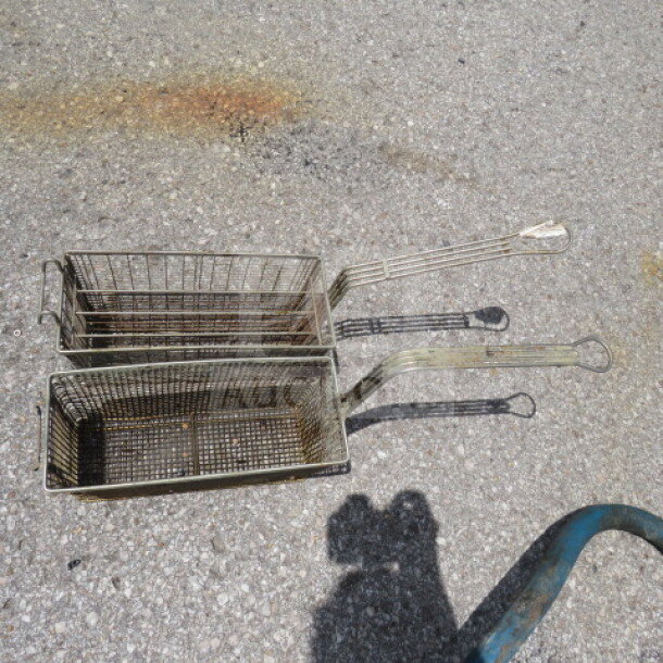 Assorted deep fry baskets with handles, metallic finish, visible wear. Set of two. Ideal for restaurant use.