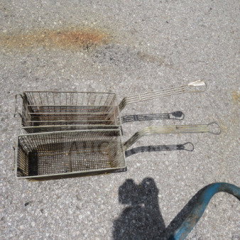 Assorted deep fry baskets with handles, metallic finish, visible wear. Set of two. Ideal for restaurant use.