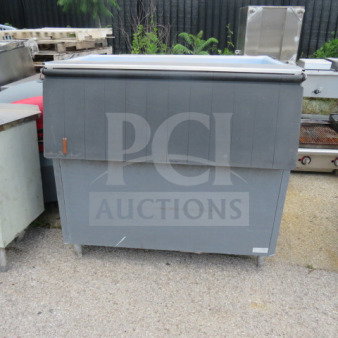 Gray ice bin, dimensions 48x35x46 inches, in used condition with stainless steel lid and visible wear.
