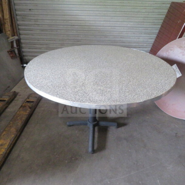 Round laminate table on pedestal base, measuring 48x30 inches. Shows minor wear, suitable for home or office use.