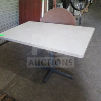 White laminate table with pedestal base, 48x30x30 inches. Sturdy condition, ideal for office or dining use.