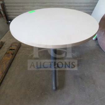 White round laminate table with pedestal base, 36x30 inches. Appears in good condition, suitable for various uses.