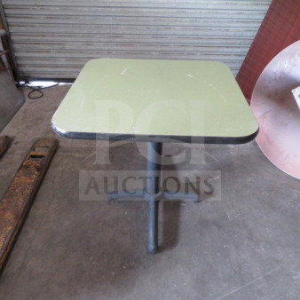 One laminate table with a pedestal base, measuring 30x30x30 inches. Green surface, metal base, good condition.
