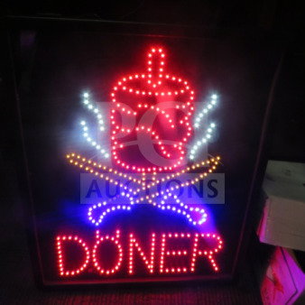LED sign with "DONER" illuminated in red, featuring a stylized kebab image. New condition, electric-powered.