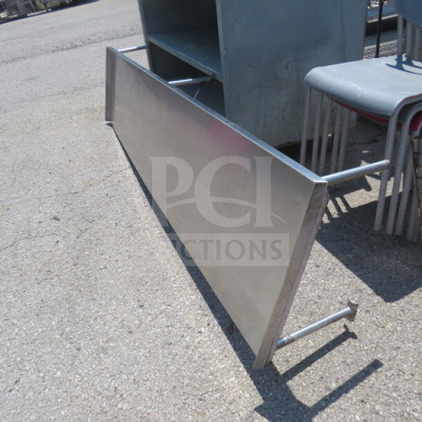Stainless steel shelf, 96x22x13 inches, good condition, suitable for industrial or commercial use.