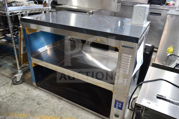 Brand new Prince Castle DHB2PT-44D pass-through holding bin, 2 shelves, 4 pans, 208-240 volts, minor scratches.