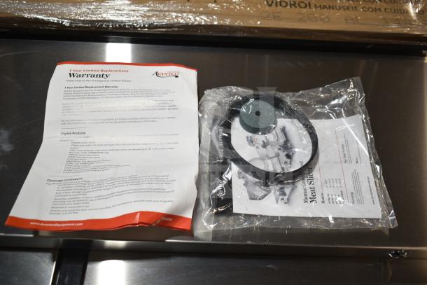 Avantco ASM0013 13" Meat Slicer packaging, including warranty document and sealed accessories. 3/4 hp, 120V, automatic/manual use.