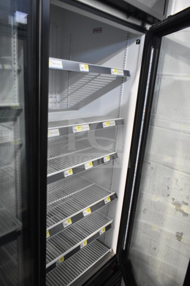 2019 True GDM-72F-HC Commercial 3 Door Reach In Freezer, open door view, shelves intact, excellent condition.