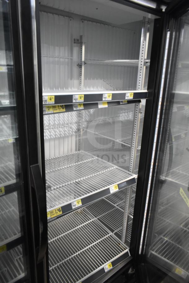 2019 True GDM-72F-HC commercial 3-door freezer, shelves empty, visible price tags, in excellent condition.