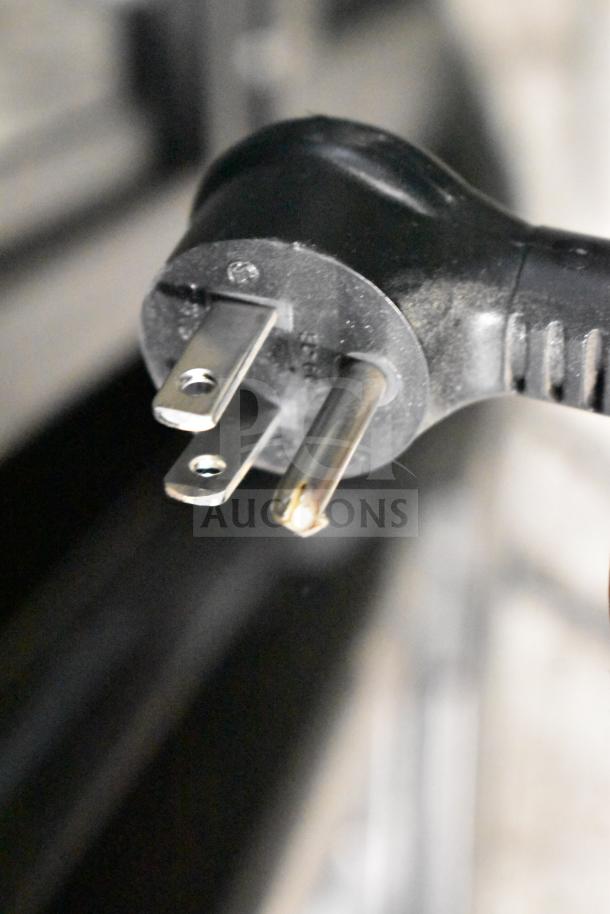 Close-up of a plug for a 2019 True GDM-72-HC commercial cooler, 115V, 1 phase, showing power compatibility.