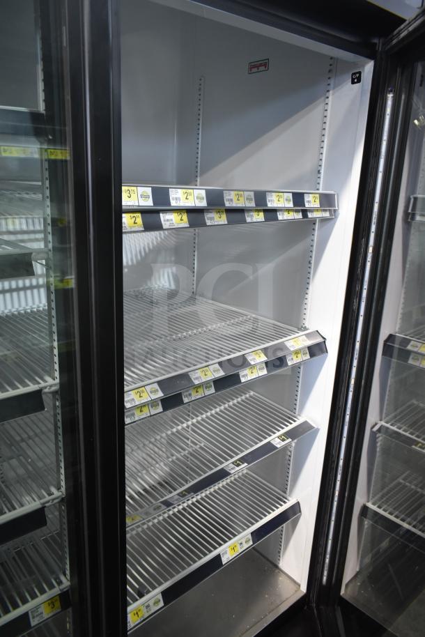 2019 True GDM-72-HC commercial 3-door reach-in cooler, empty, with adjustable shelves, tags visible. 115 volts, 1 phase.