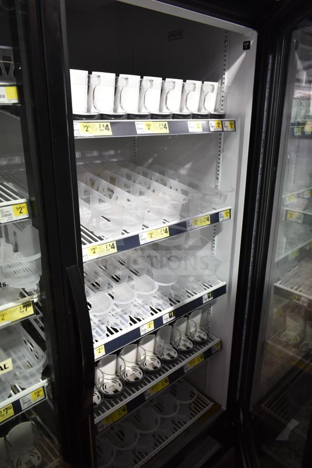 2019 True GDM-49-HC commercial 2 door cooler, white interior, glass doors, price tags, shelves for retail display.