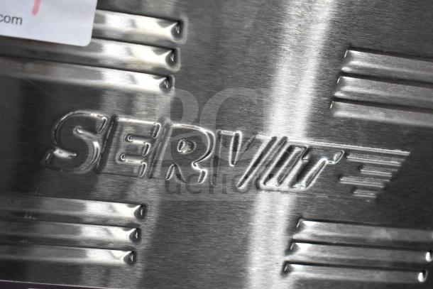 Close-up of embossed "SERVIT" logo on 2025 ServIt 423FW150L electric countertop food warmer, stainless steel finish.