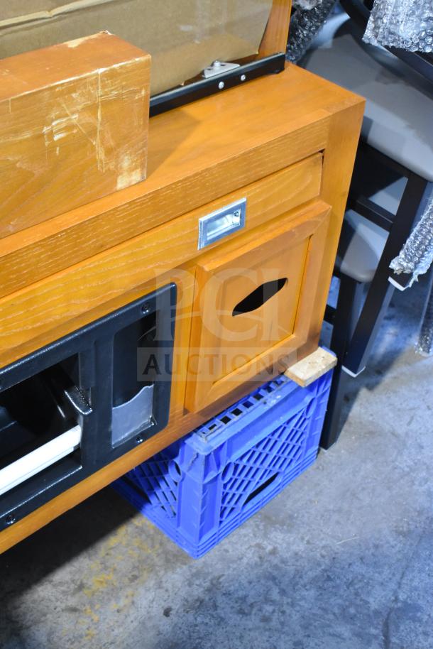 Brand new Avantco 178HBB95HC pastry display case, wood pattern, minor scratch and dent, with storage compartments.