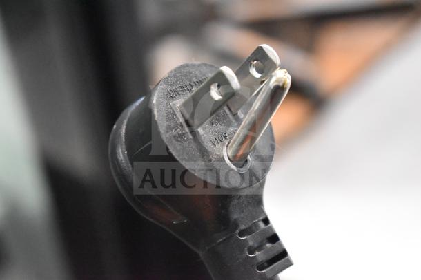 Close-up of the plug for a 2019 True GDM-49-HC commercial cooler, showing prongs and markings for 115 volts, 1 phase.