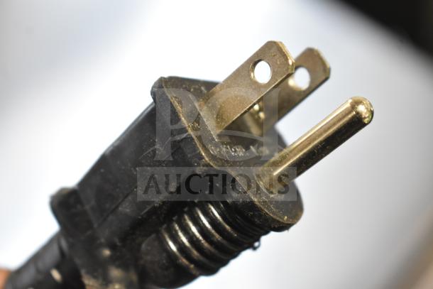 Close-up of a power plug for the Avantco 194EUCH160A ice machine, showing standard prongs and black casing.