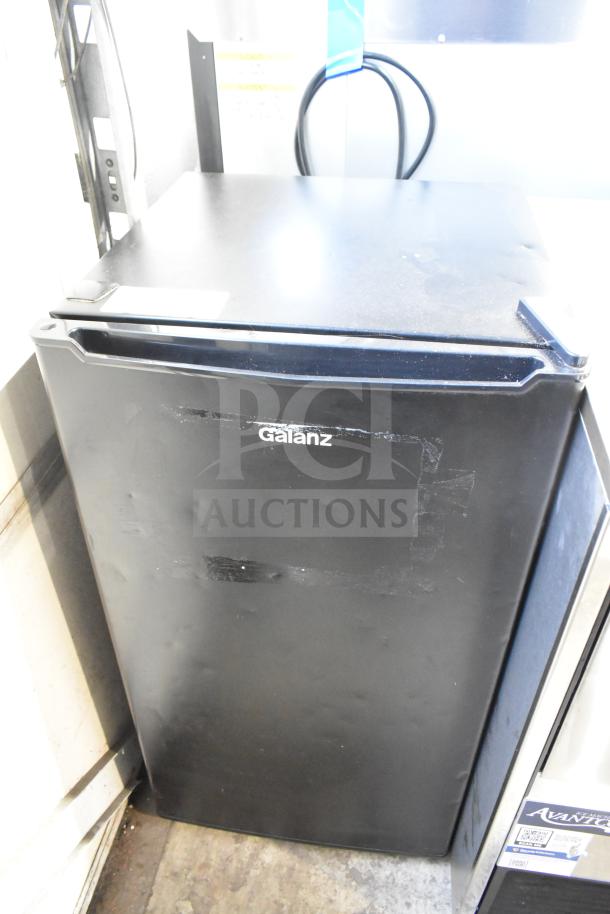 Galanz GLR33MBKE23 Mini Cooler, black, 115 Volts, 1 Phase, visible wear, Galanz logo on front.
