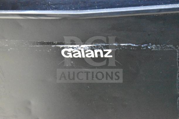 Galanz GLR33MBKE23 mini cooler, black, visible brand logo, some surface wear. 115 volts, 1 phase.