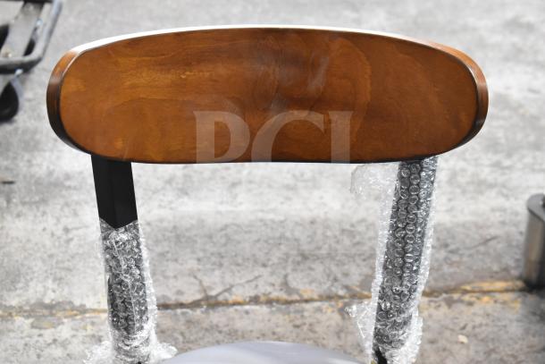 Brand new Lancaster Table & Seating Boomerang dining chair with wooden back, gray cushion, metal frame, Model 164CBMRGBFRN.