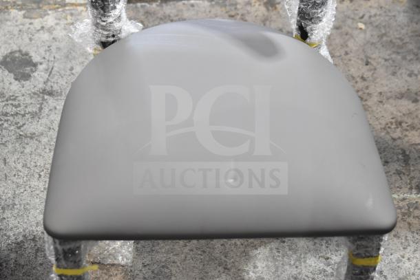 16 new Lancaster Boomerang dining chairs, model 164CBMRGBFRN, with gray seat cushions, wooden backrests, metal frames.