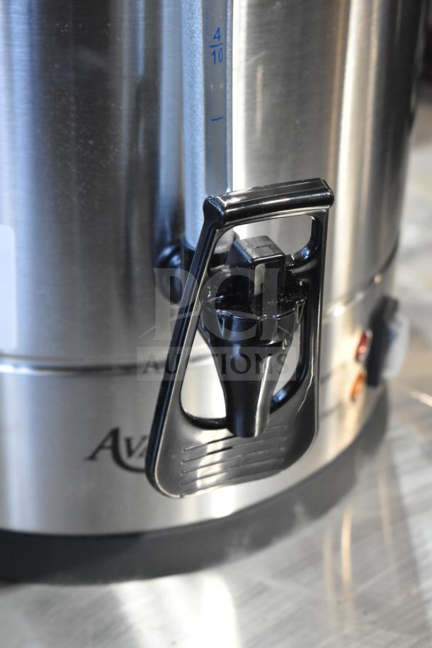 Brand new Avantco 177CU100ETL coffee urn, stainless steel, 100 cup capacity, visible markings, slight scratch, pristine condition.