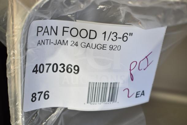 Label on plastic wrap showing "Pan Food 1/3-6", Anti-Jam 24 Gauge, model 4070369, barcode, and handwritten numbers.