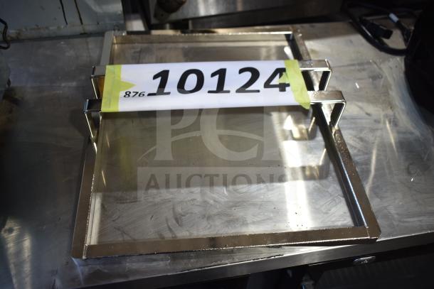 Metal frame with attached sign reading "10124" and number "876" visible, used for item identification in auctions.
