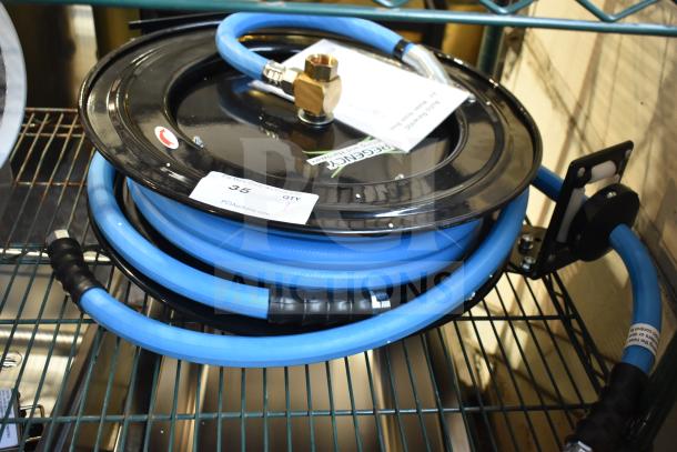 BRAND NEW Regency black powder-coated steel hose reel with blue hose, slight scratches; includes brass fittings and label tag.