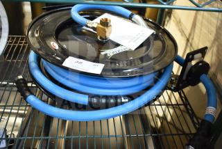 BRAND NEW Regency black powder-coated steel hose reel with blue hose, slight scratches; includes brass fittings and label tag.