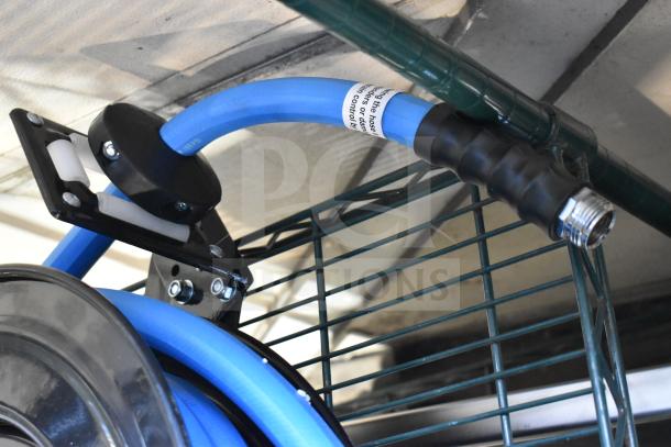Regency black powder-coated steel hose reel with blue hose, wall-mounted. Scratch and dent condition, with visible labeling.