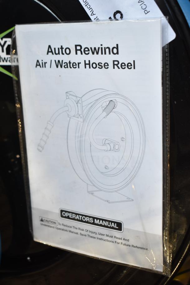 Regency auto-rewind black powder-coated steel hose reel with hose, brand new, shown with operators manual.