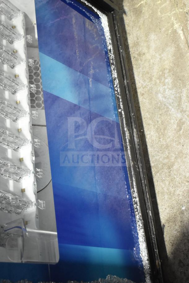 Crane 5800-4 vending machine partially visible showing dispensing mechanism, edge damage, and blue panel. 115V, 1-Phase.