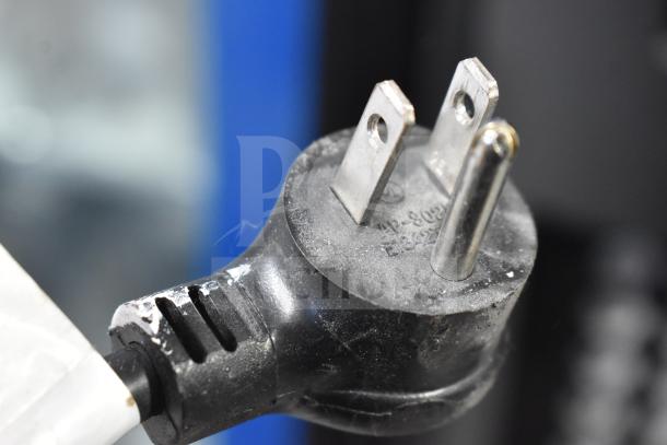 Close-up of a power plug for a Crane 5800-4 commercial drink vending machine, emphasizing electrical connection details.