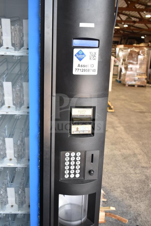 Crane 5800-4 vending machine with bill acceptor, visible glass damage. Sam’s Club asset ID 7712958745. 115 volts, 1 phase.