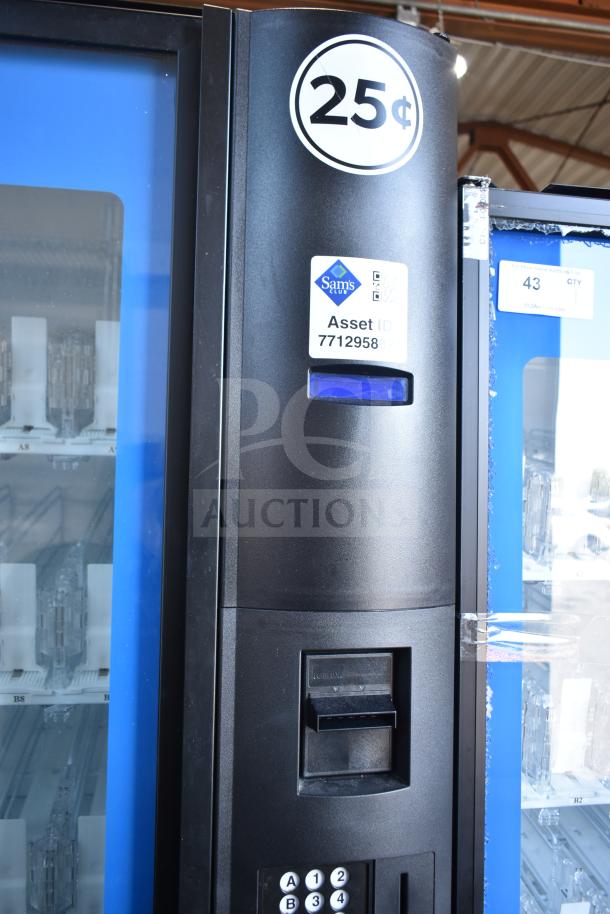 Crane 5800-4 vending machine, black, 25¢ coin slot, bill acceptor, Sam's Club asset tag visible.