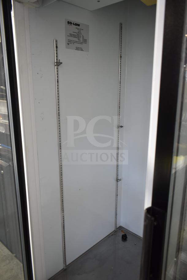 So-Low DHF4-49GD commercial freezer interior, shelving tracks visible, good condition. Model and specs label on wall.