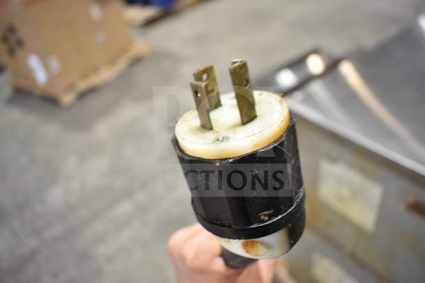 Close-up of electrical plug for Middleby Marshall CTX DZ33T commercial pizza oven, showing prongs and casing.