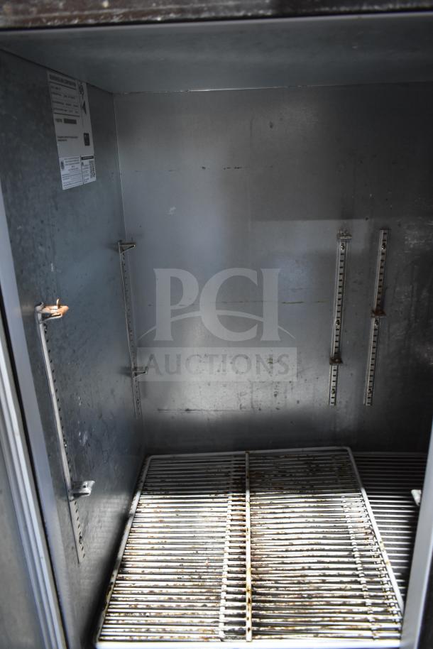 Beverage Air BB48Y-1-B 2-door undercounter back bar cooler interior, features metal shelving and adjustable brackets.