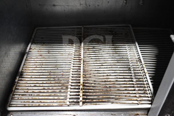 Beverage Air BB48Y-1-B cooler interior with used shelving, visible wear, and rust. For commercial undercounter use. 115V, 1 phase.