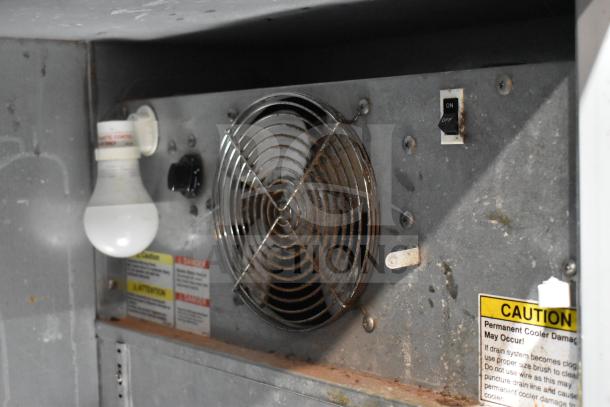 Beverage Air BB48Y-1-B cooler interior, showing an on/off switch, fan, light bulb, and caution labels. 115V, 1 Phase.