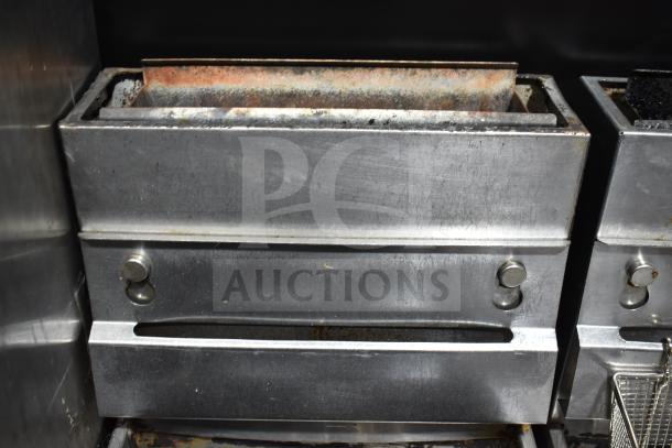 Pitco Frialator commercial gas deep fryer with visible wear, on casters, featuring metal construction and front controls.