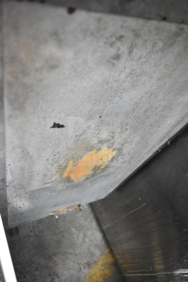 Pitco Frialator commercial gas fryer, floor style with casters. Visible interior wear and rust marks on the surface.