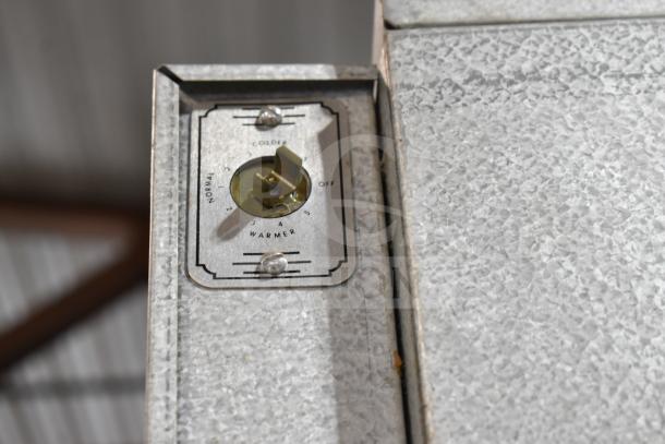 Traulsen RHT 2-32NUT cooler thermostat dial, settings for colder and warmer, metal casing.