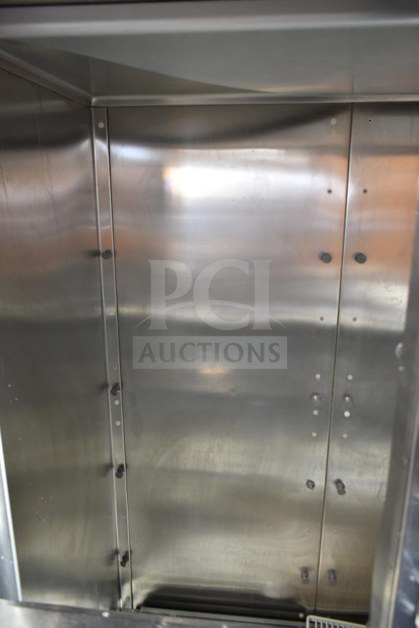 Traulsen RHT 2-32NUT cooler interior, stainless steel finish, commercial use, four half-size doors, 115V, 1 phase.