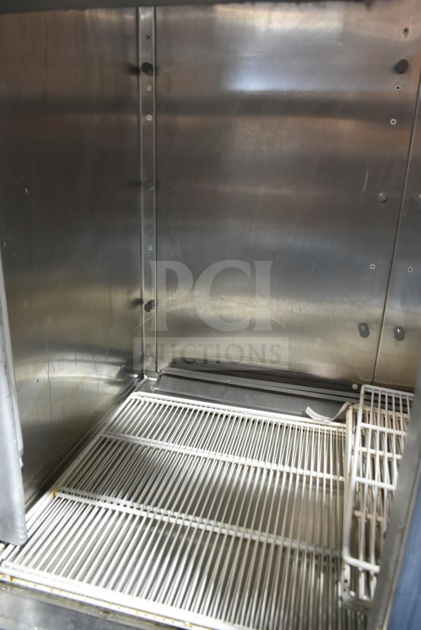 Traulsen RHT 2-32NUT commercial reach-in cooler interior; stainless steel with wire shelving, 115V, 1 phase.