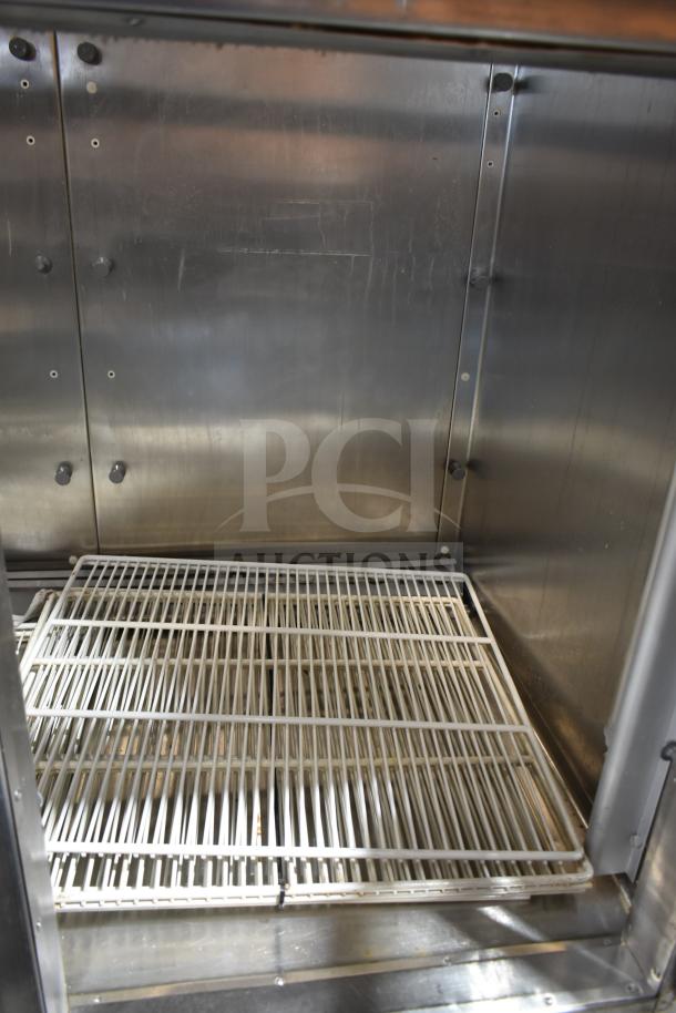 Traulsen RHT 2-32NUT commercial cooler interior, four half-size doors, metal shelving, 115V, 1 phase.